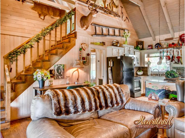 Living room with gas fireplace and stairs leading to the upstairs loft area